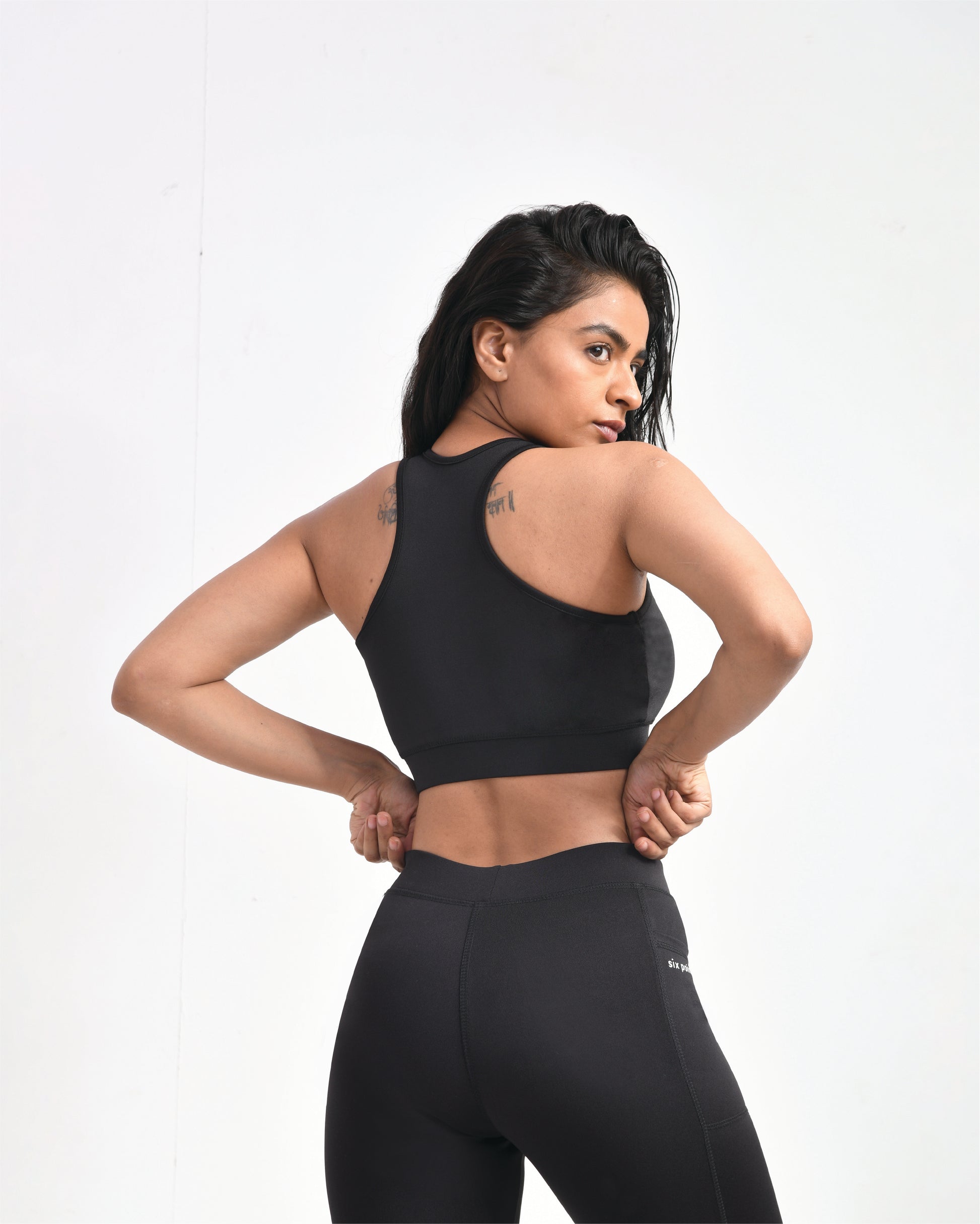 Black gym sports bra for women with racerback design, paired with black leggings, highlighting support for intense workouts.