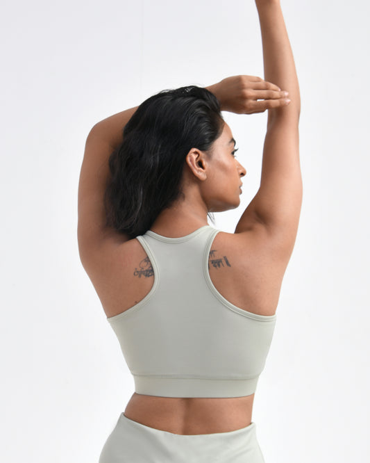 Women wearing a light green gym sports bra designed for high-intensity workouts, featuring a racerback style, ideal for comfortable and stylish gym wear.