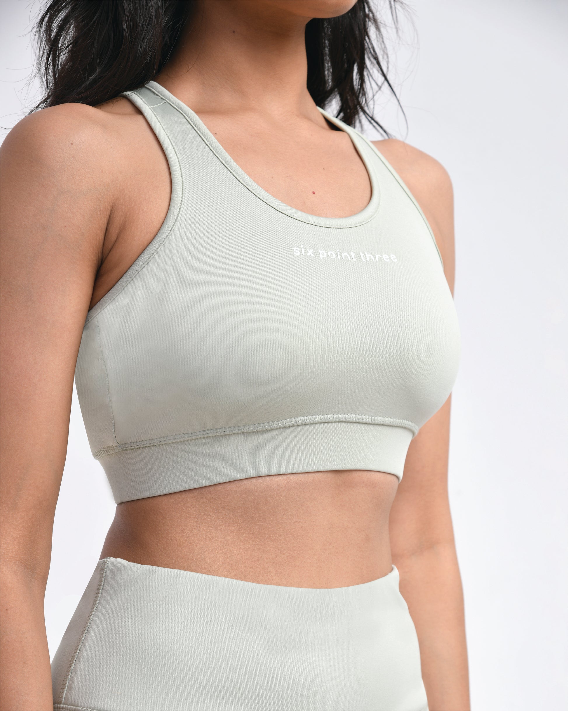 Girl in a mint green Six Point Three sports bra, designed for gym workouts, providing high support and seamless comfort, perfect as a sports bra for women.